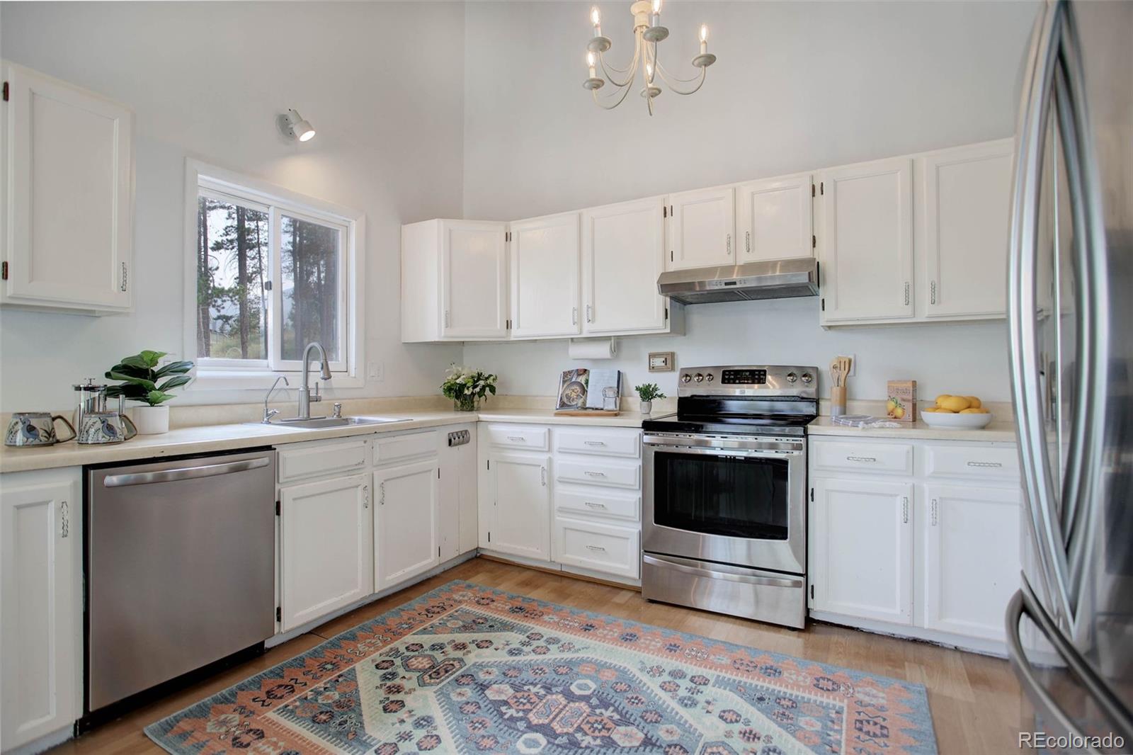 7359 Brook Forest Way Evergreen, CO 80439 - Photo 12 of 40 a kitchen with a white cabinets and window