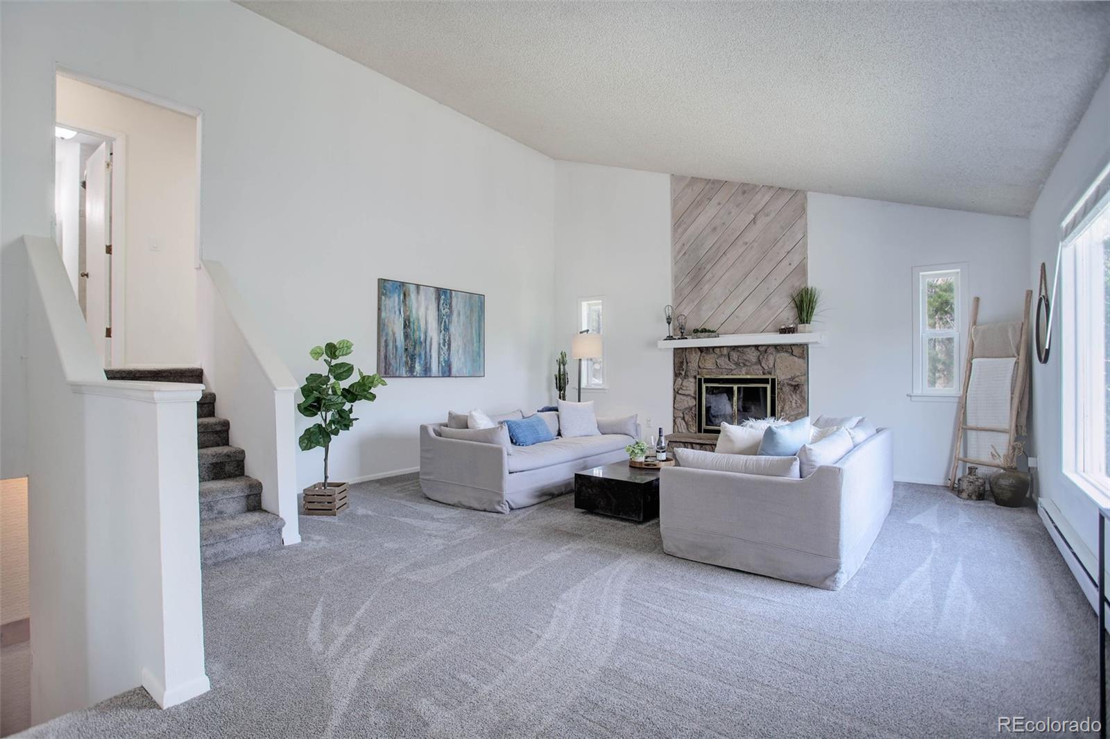 7359 Brook Forest Way Evergreen, CO 80439 - Photo 15 of 40 a living room with furniture and a fireplace
