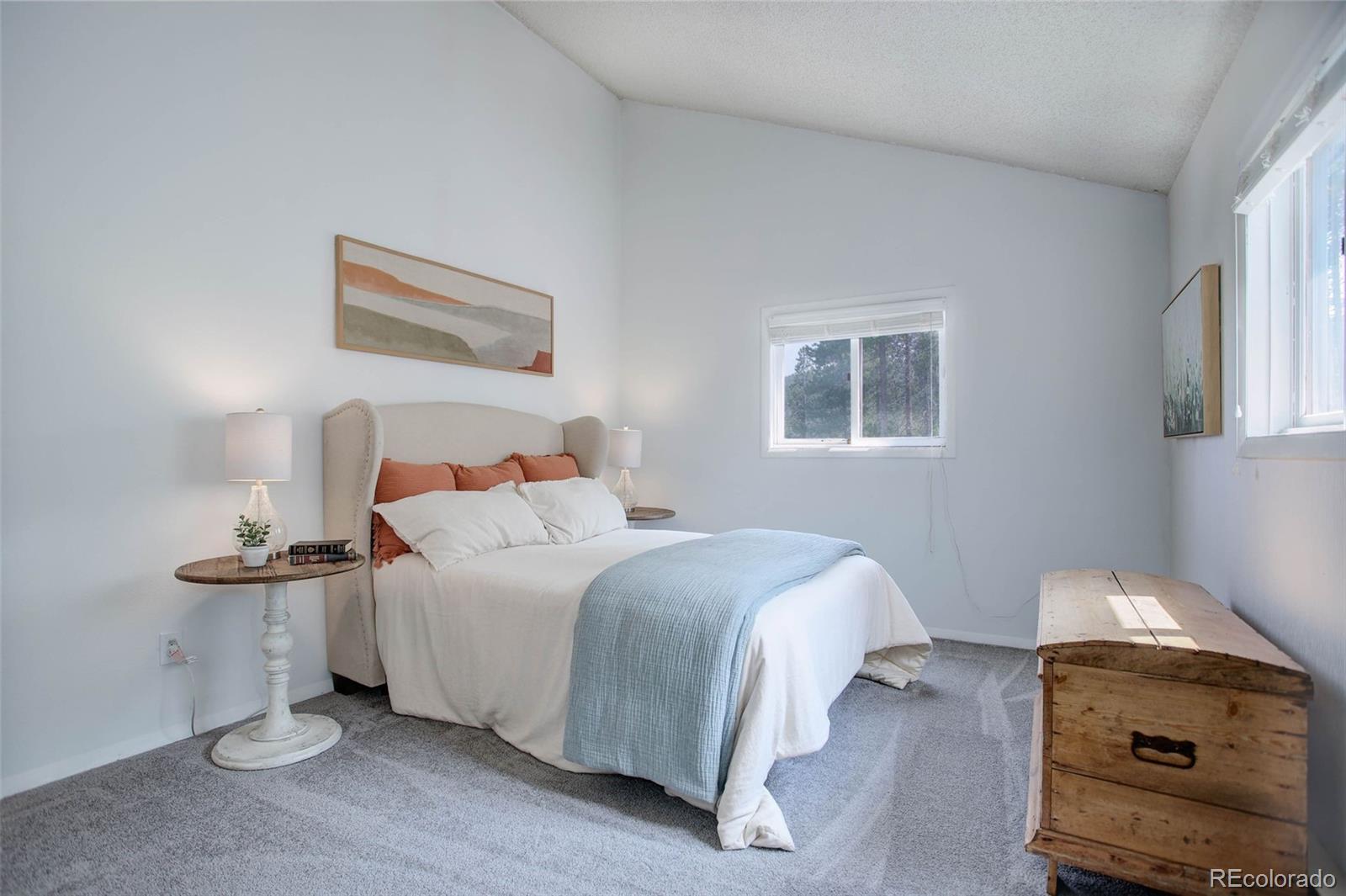 7359 Brook Forest Way Evergreen, CO 80439 - Photo 16 of 40 a bedroom with a bed and a painting on the wall