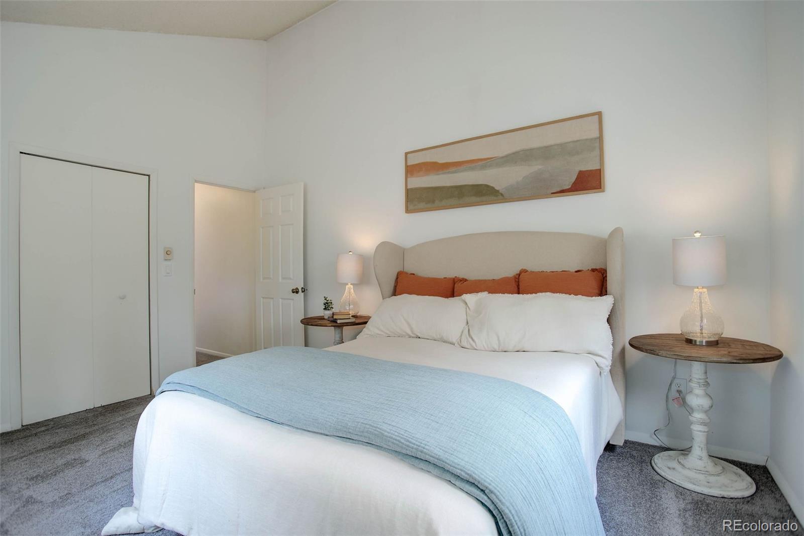 7359 Brook Forest Way Evergreen, CO 80439 - Photo 20 of 40 a bedroom with a bed and a lamp