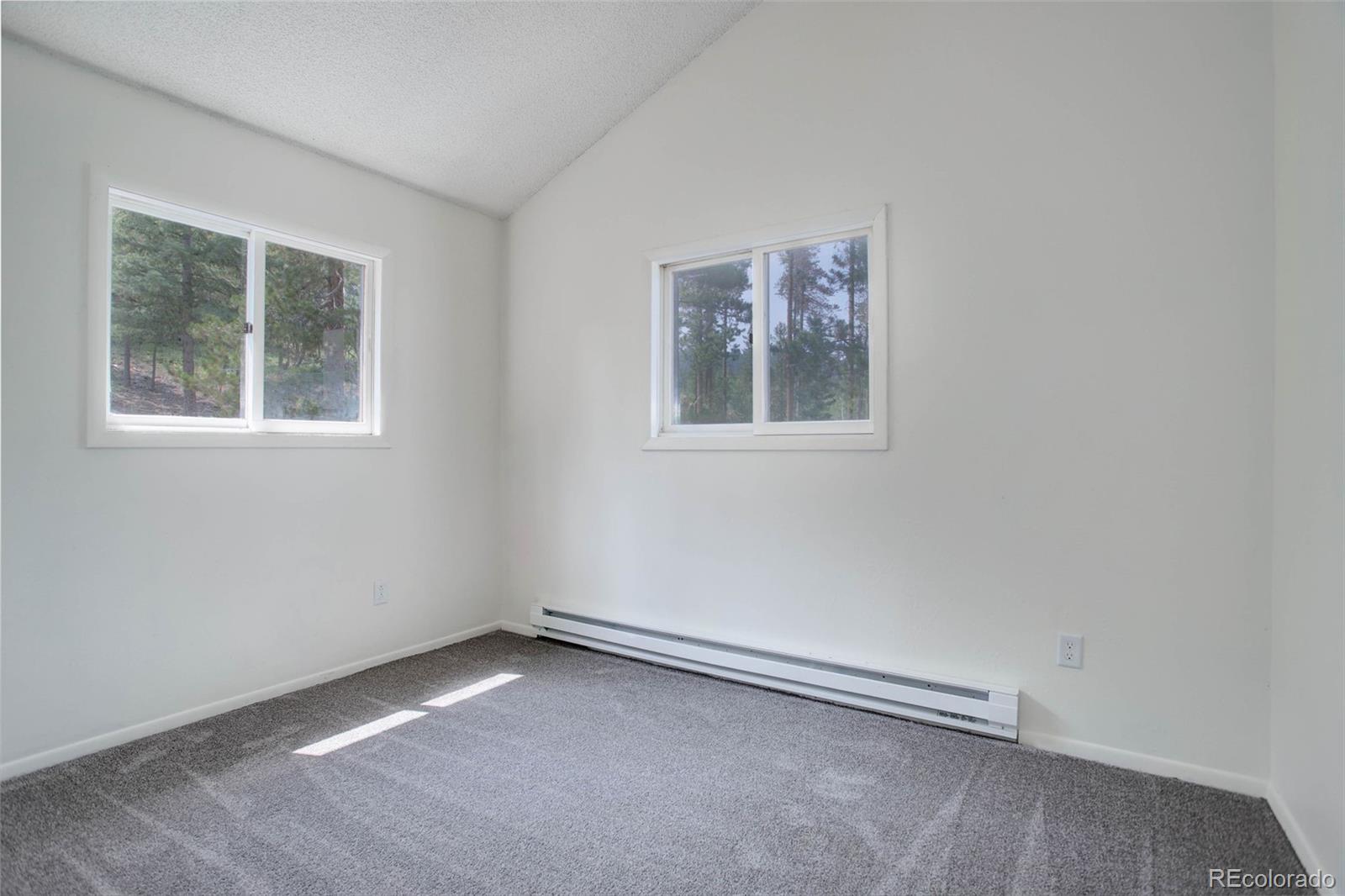 7359 Brook Forest Way Evergreen, CO 80439 - Photo 22 of 40 an empty room with a window