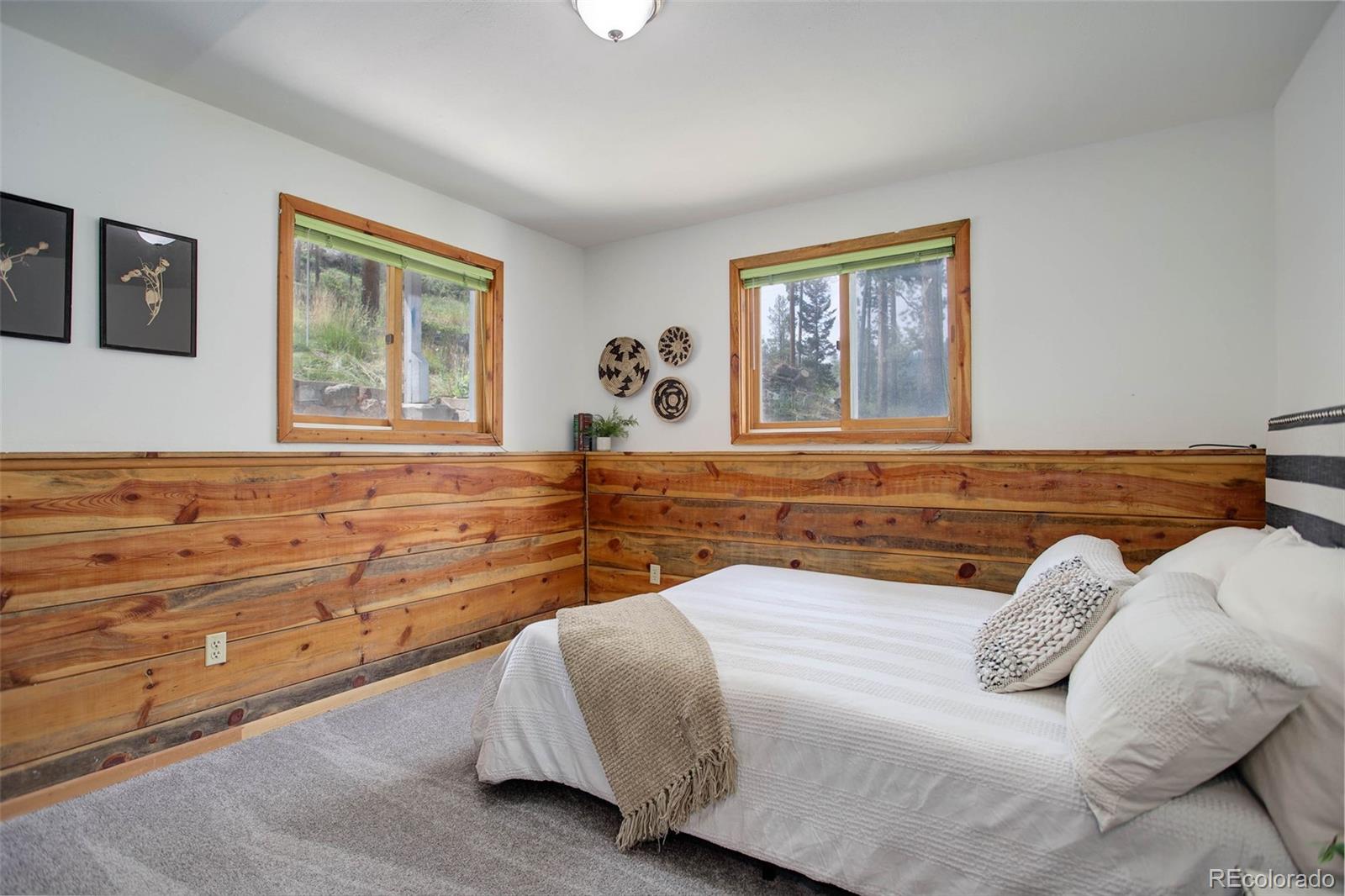 7359 Brook Forest Way Evergreen, CO 80439 - Photo 25 of 40 a bedroom with a large bed and a window