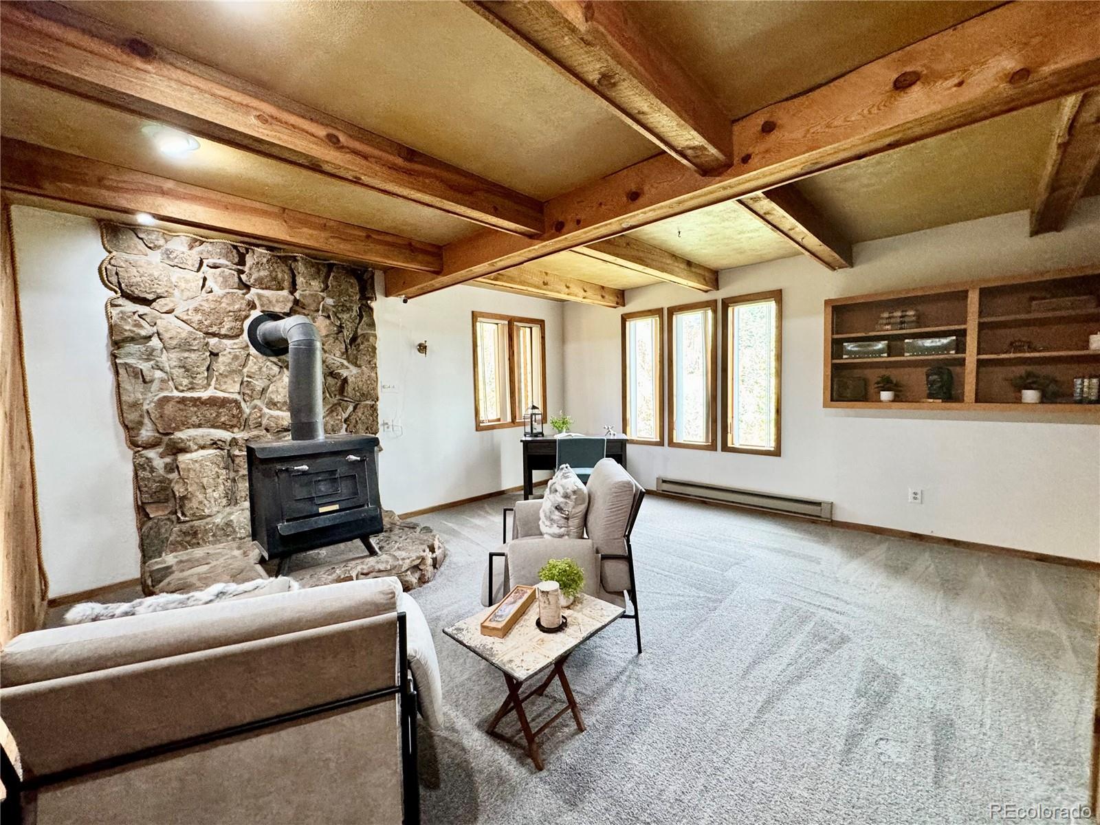 7359 Brook Forest Way Evergreen, CO 80439 - Photo 27 of 40 a living room with furniture and a flat screen tv