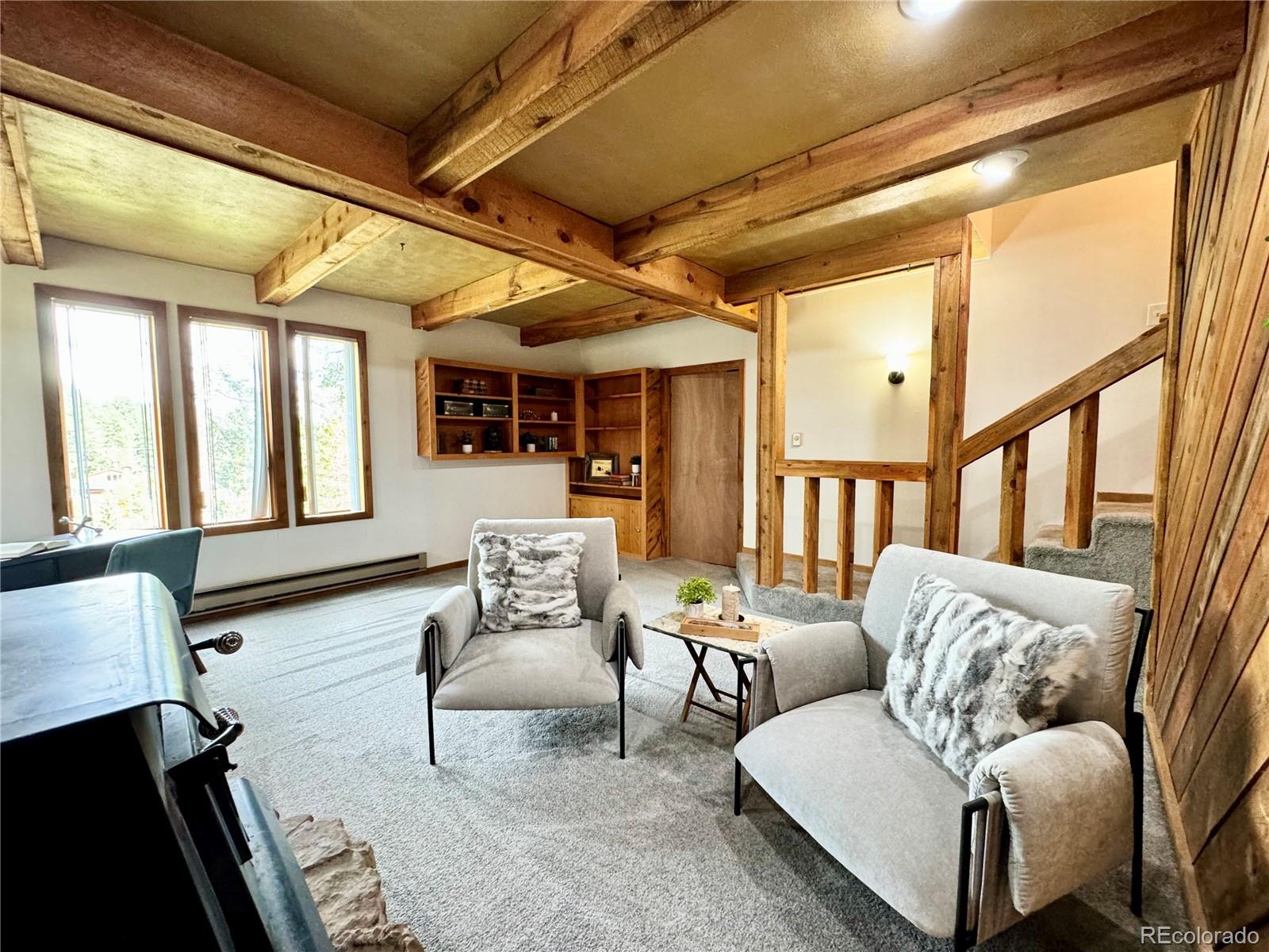 7359 Brook Forest Way Evergreen, CO 80439 - Photo 28 of 40 a living room with furniture and a large window