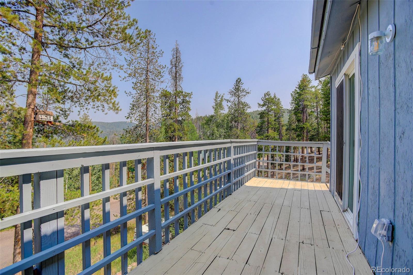 7359 Brook Forest Way Evergreen, CO 80439 - Photo 34 of 40 a view of balcony with wooden floor and fence