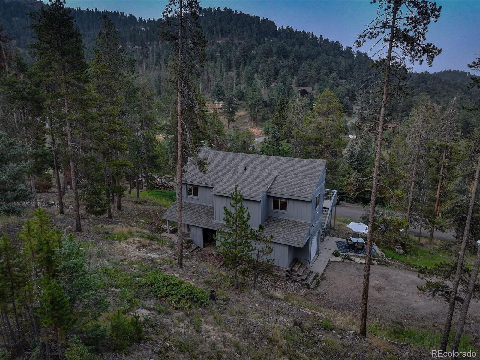 7359 Brook Forest Way Evergreen, CO 80439 - Photo 36 of 40 a view of a house with a yard and sitting area
