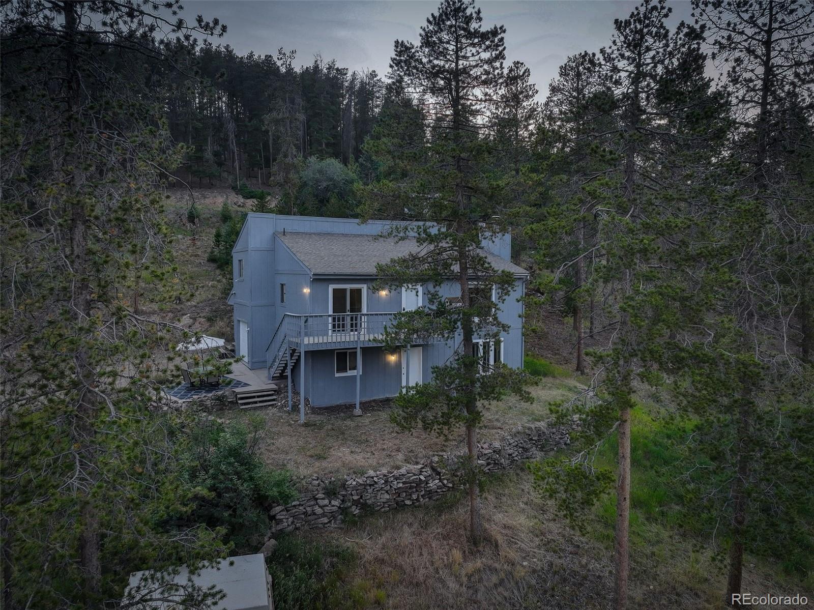 7359 Brook Forest Way Evergreen, CO 80439 - Photo 38 of 40 a view of a house with a yard