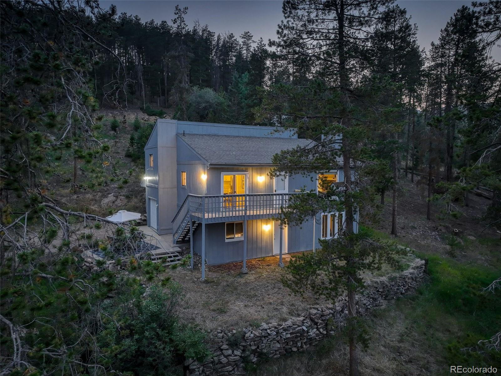 7359 Brook Forest Way Evergreen, CO 80439 - Photo 4 of 40 a view of a house with a yard