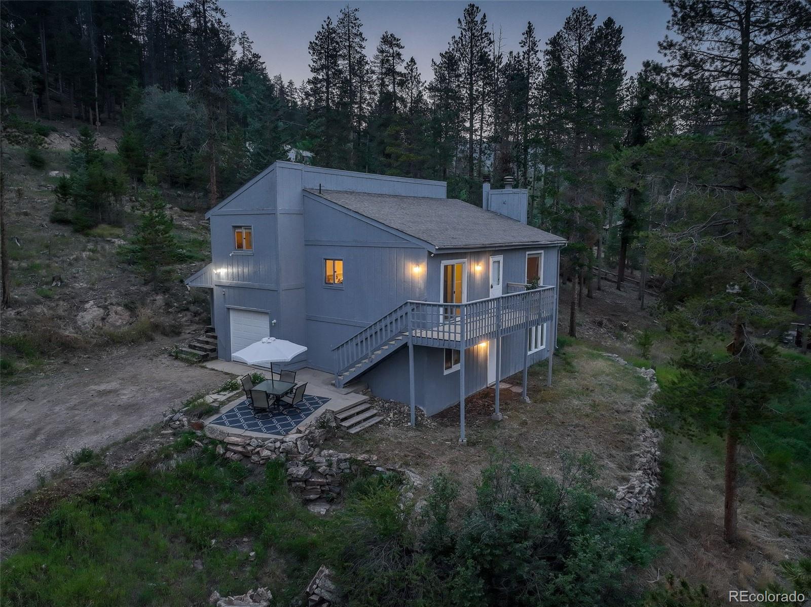 7359 Brook Forest Way Evergreen, CO 80439 - Photo 5 of 40 a backyard of a house with table and chairs