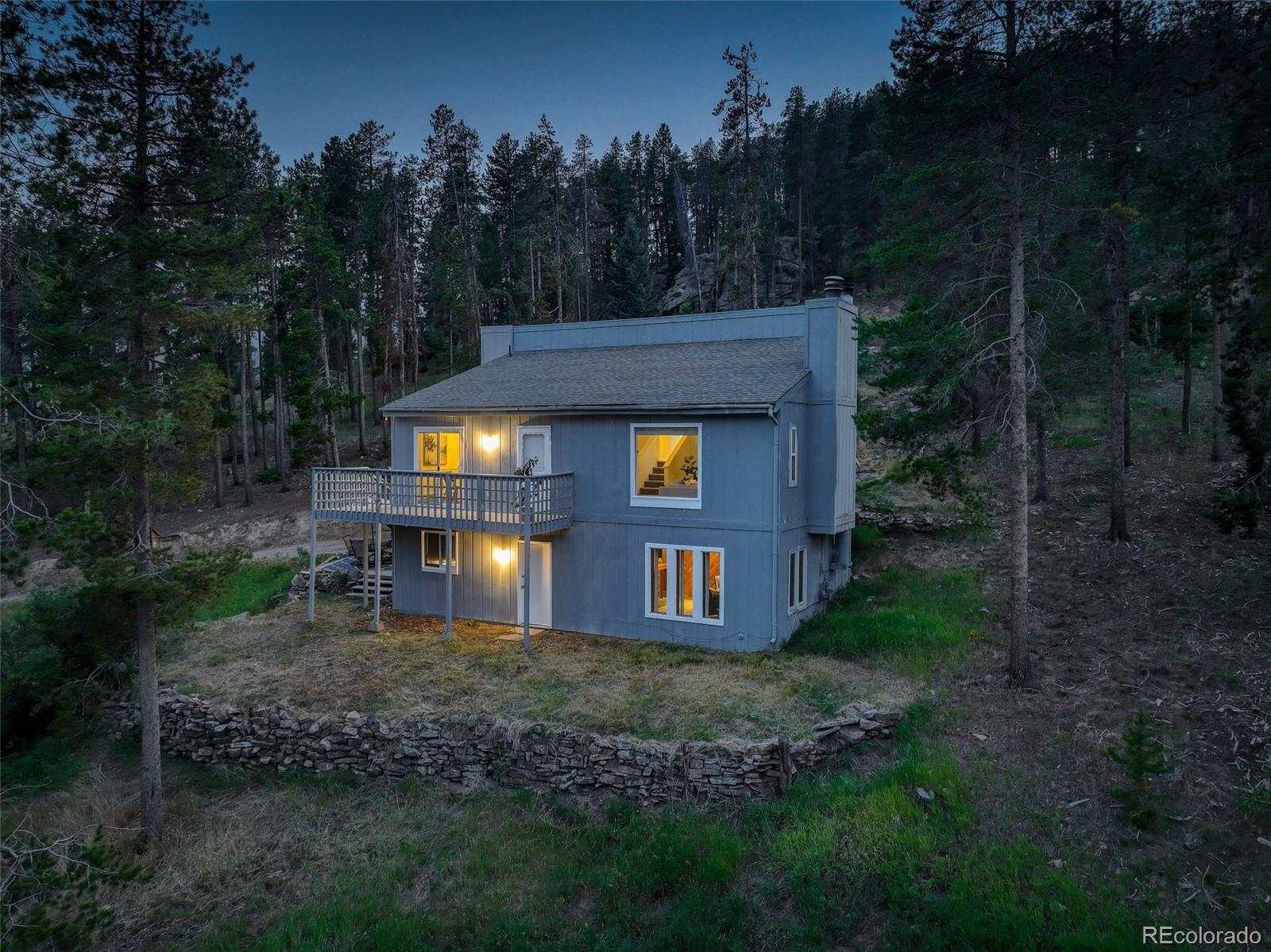 7359 Brook Forest Way Evergreen, CO 80439 - Photo 6 of 40 a view of a house with backyard and trees