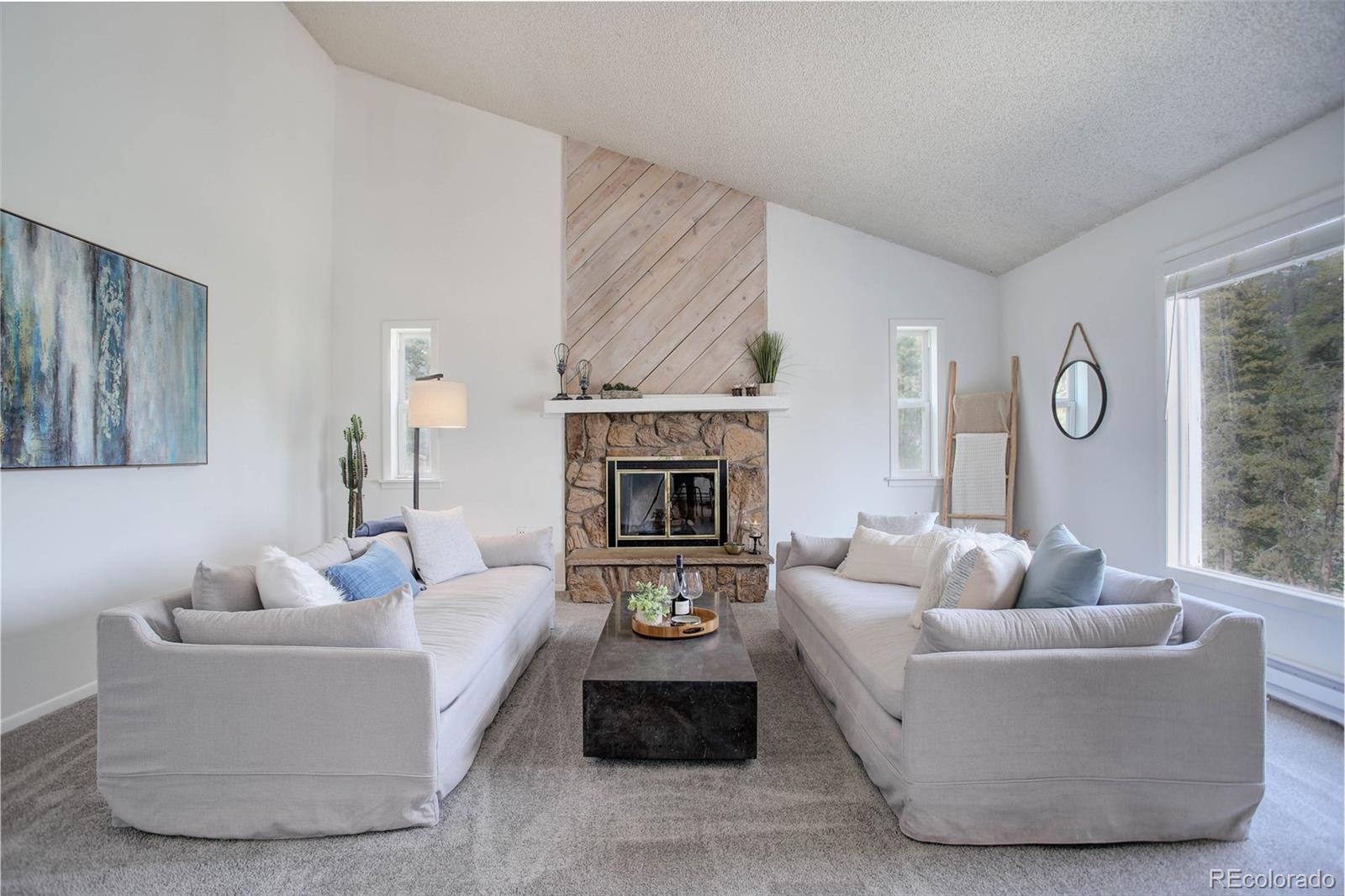 7359 Brook Forest Way Evergreen, CO 80439 - Photo 8 of 40 a living room with furniture and a fireplace