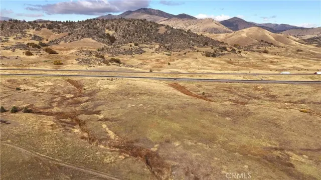 a view of a large mountain with mountains in the background