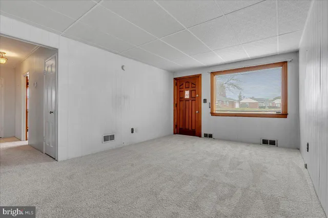 an empty room with windows and closet