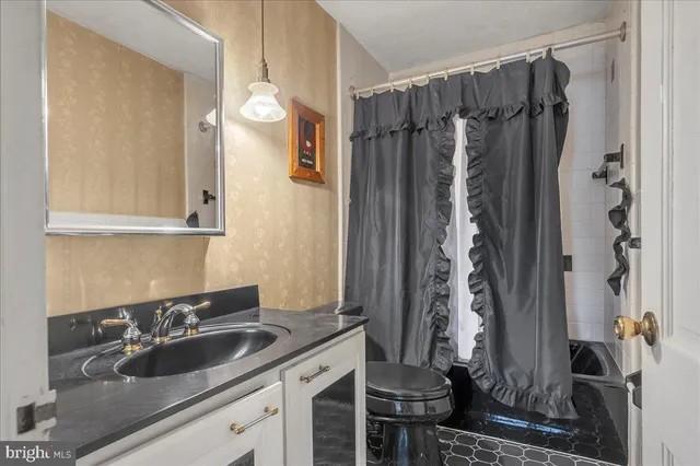 a bathroom with a double vanity sink and mirror