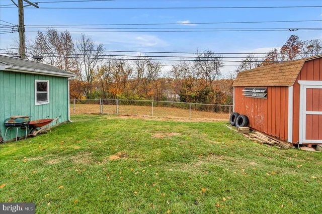a view of a backyard with a garden and entertaining space