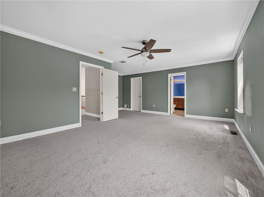 3821 Rittenhouse Road Lower Macungie Township, PA 18062 - Photo 43 of 62 A spacious, naturally illuminated room featuring a ceiling fan and plush carpeting, offering ample space for relaxation.