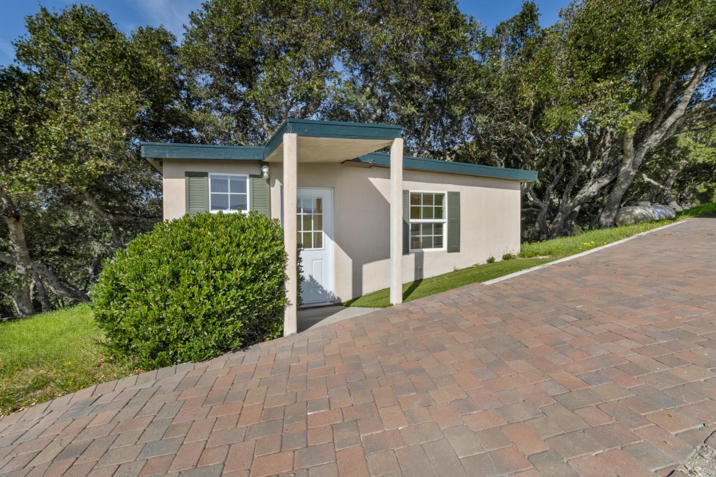 320 El Caminito Road Carmel Valley, CA 93924 - Photo 49 of 62 a view of a house with a yard and potted plants