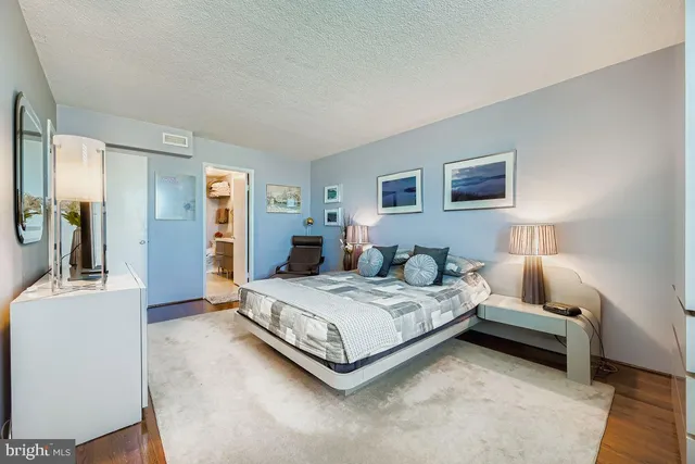 a spacious bedroom with a bed and a couch