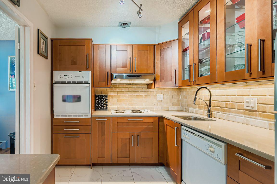 1101 St Paul Street, Unit 1410 Baltimore, MD 21202 - Photo 2 of 29 a kitchen with stainless steel appliances granite countertop a sink and dishwasher next to a window