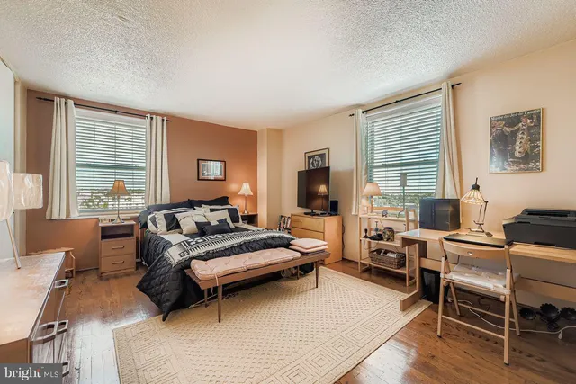 a bedroom with furniture and a large window