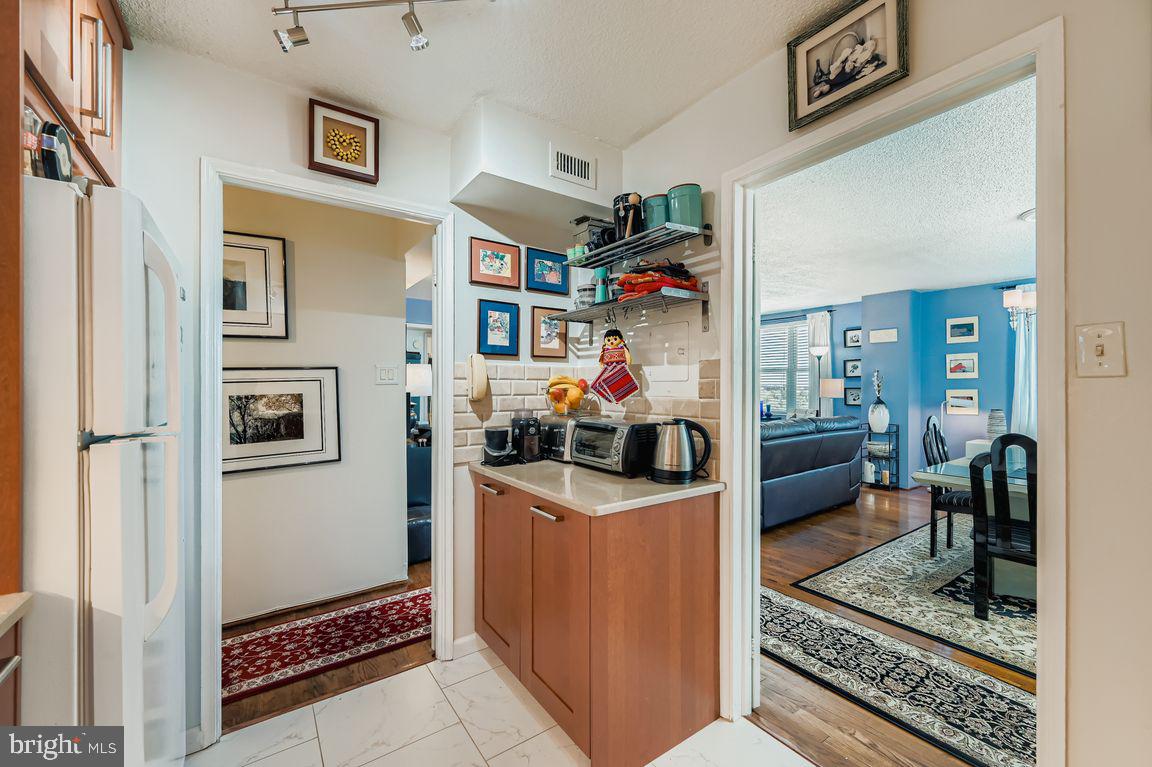 1101 St Paul Street, Unit 1410 Baltimore, MD 21202 - Photo 5 of 29 a living room with furniture and a rug