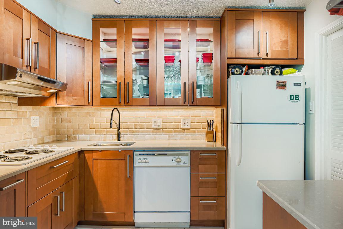 1101 St Paul Street, Unit 1410 Baltimore, MD 21202 - Photo 6 of 29 a kitchen with stainless steel appliances granite countertop a refrigerator and a sink