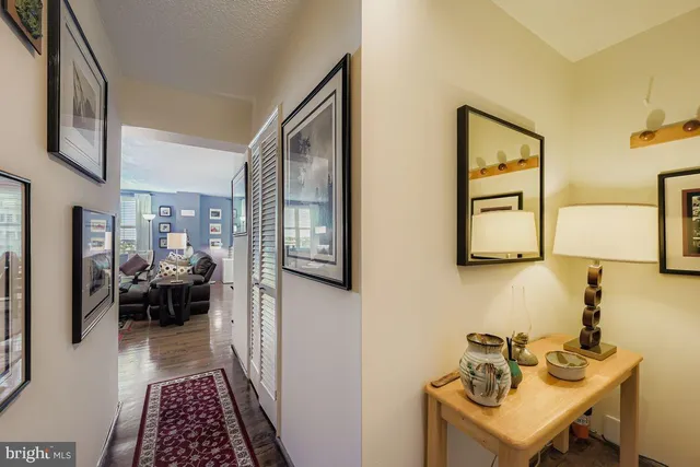 a hallway with a couch and chandelier