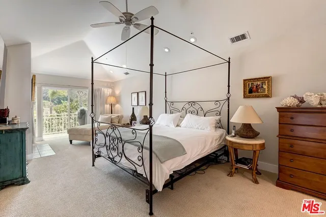 a bedroom with a bed and a fireplace