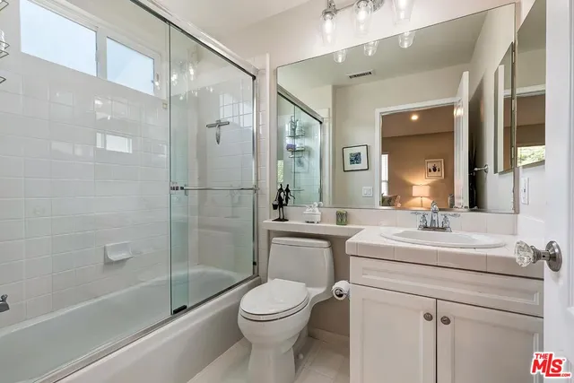 a view of a room with gym equipment and wooden floor