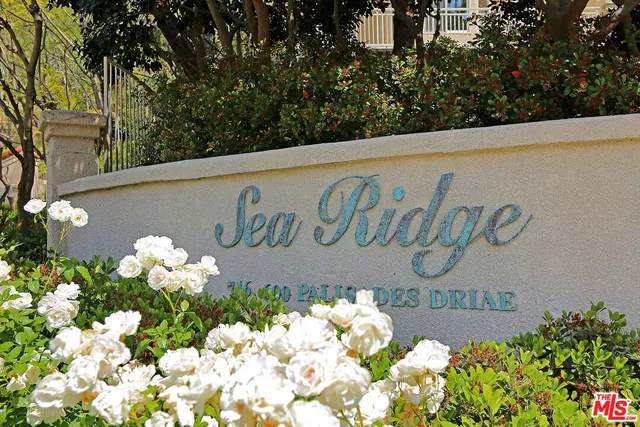 a view of swimming pool with outdoor seating and a garden