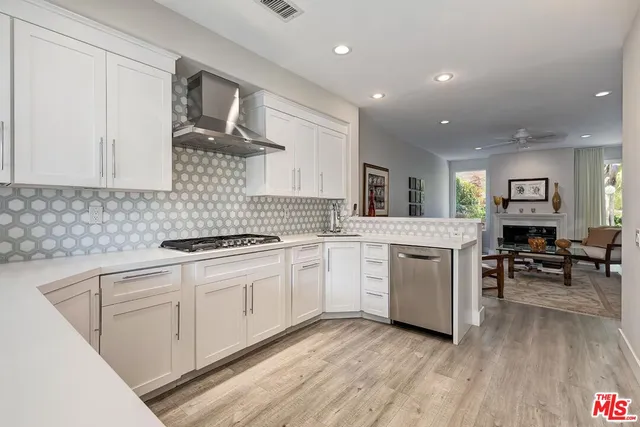 a kitchen with stainless steel appliances a stove a sink and a refrigerator
