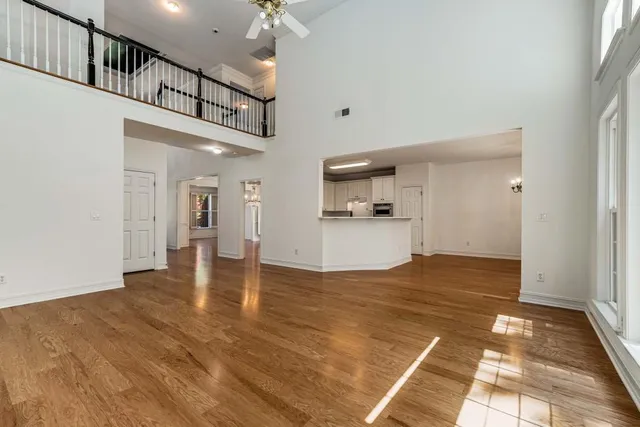 a view of an empty room with a fireplace and a window