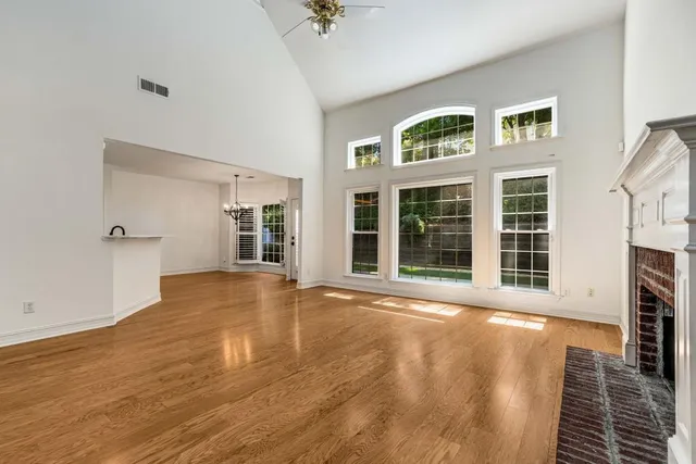 a kitchen with a sink cabinets and wooden floor