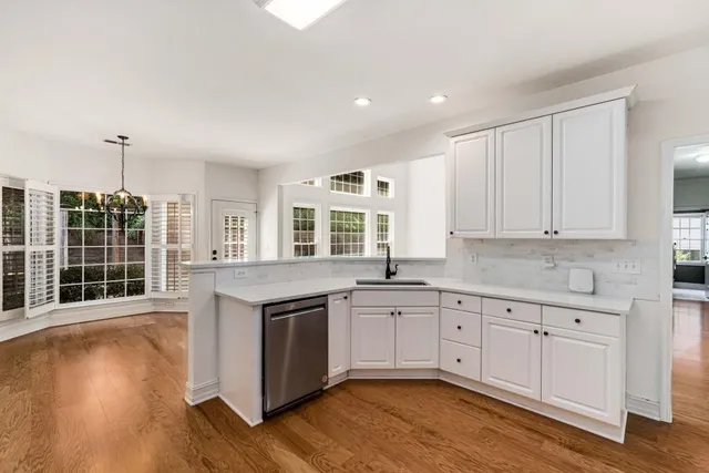 a kitchen with granite countertop a sink and cabinets