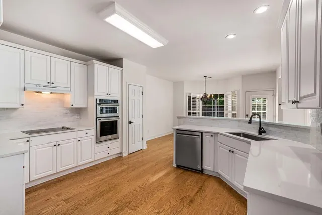 a kitchen with stainless steel appliances a refrigerator sink and cabinets