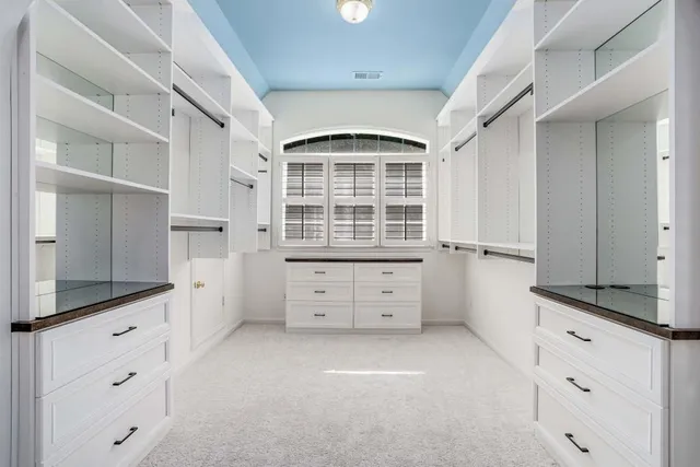 a spacious bathroom with a double vanity sink a mirror and a bathtub