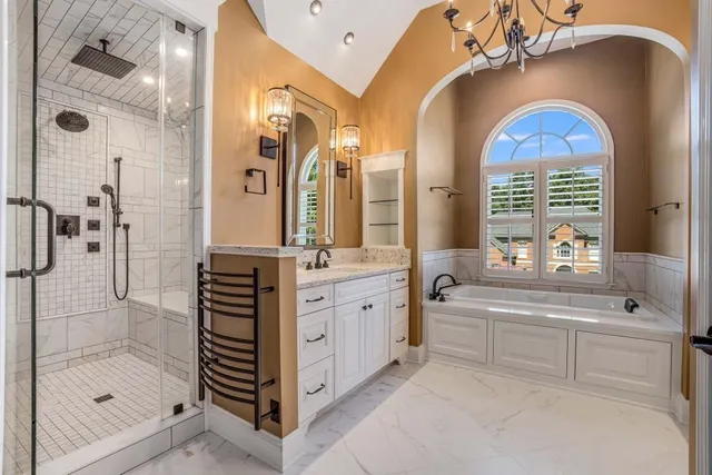 a bathroom with a bathtub and shower