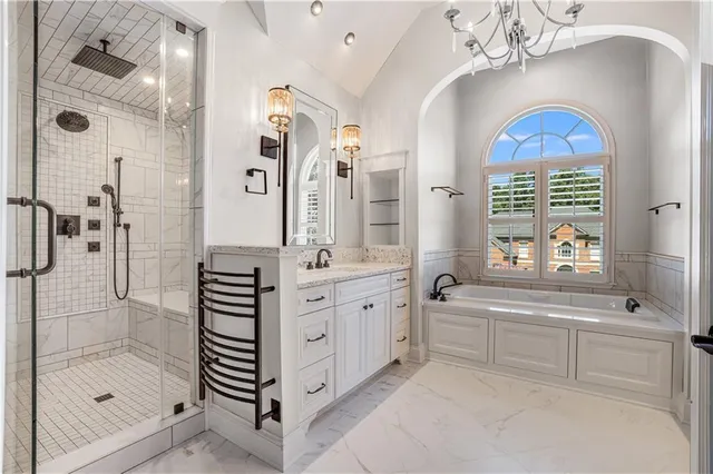 a bathroom with a sink a vanity a mirror and bathtub
