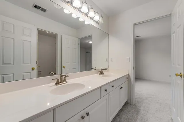 a front view of a house with a garden and yard