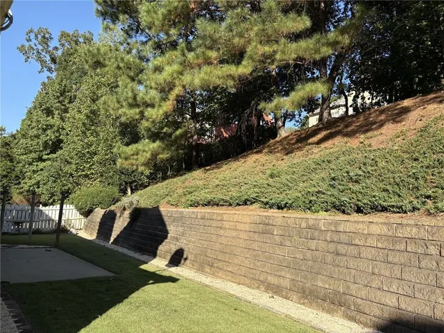 a front view of a house with a yard and trees