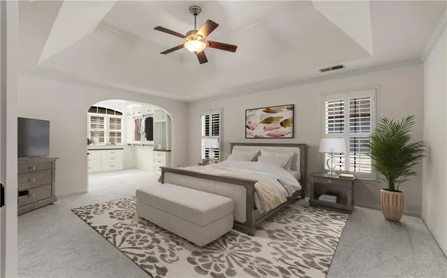 a bedroom with a large bed a chandelier and windows