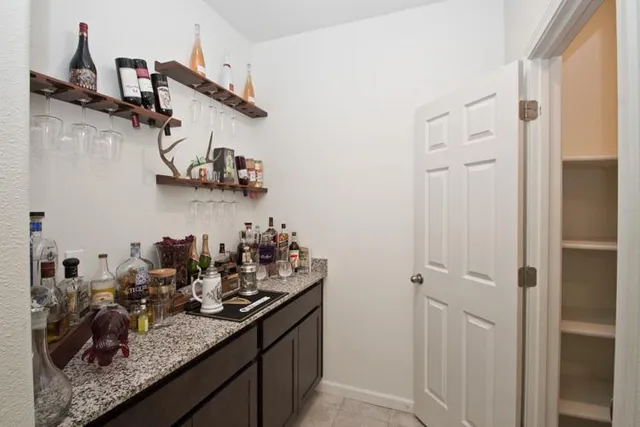 an empty room with windows and cabinet