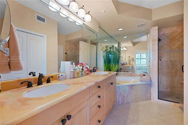 a bathroom with a double vanity sink mirror and shower