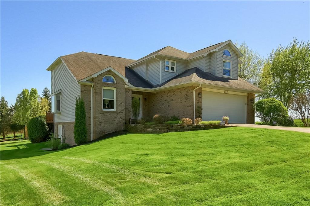 a front view of a house with a garden and yard