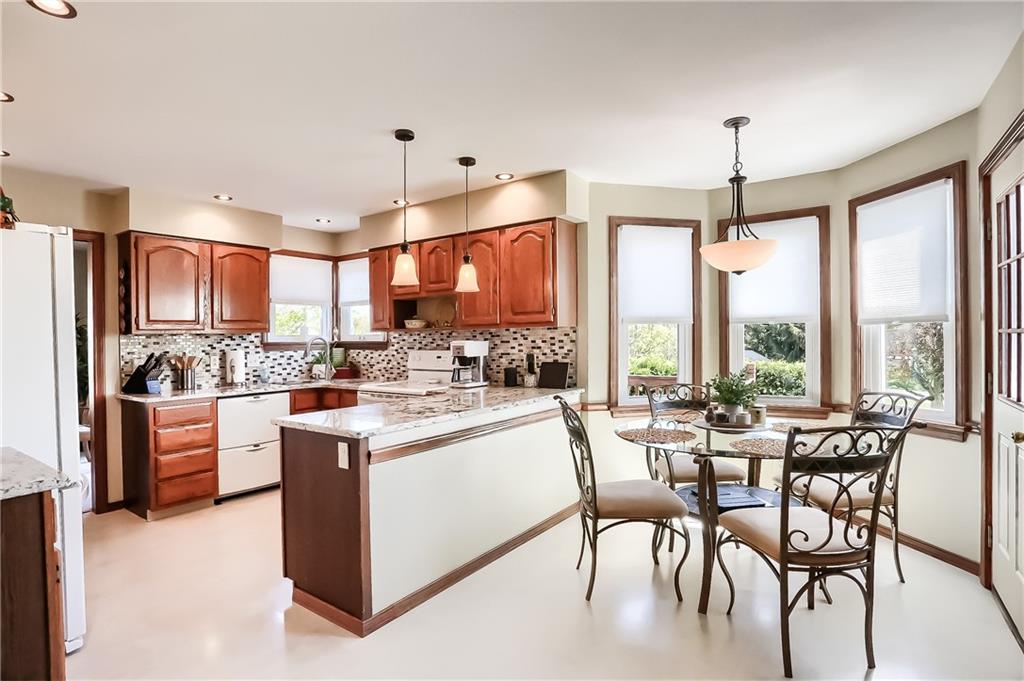 200 Holyoke Road Butler, PA 16001 - Photo 7 of 25 a kitchen with stainless steel appliances kitchen island granite countertop a table chairs and a refrigerator