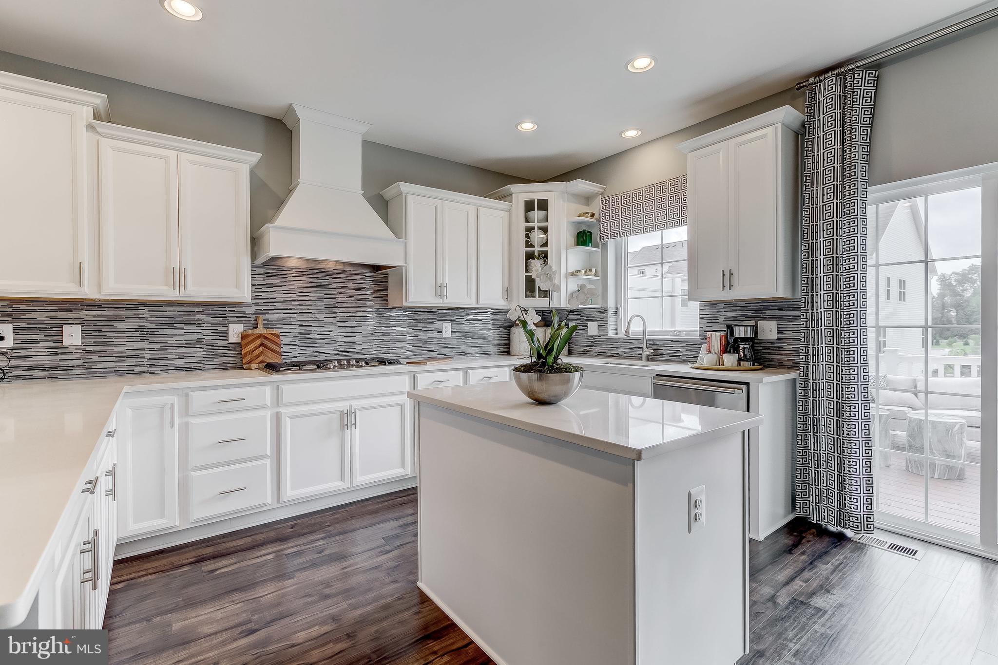 2710 Lady Slipper Road Gambrills, MD 21054 - Photo 12 of 46 a kitchen with granite countertop white cabinets white appliances a sink and a window