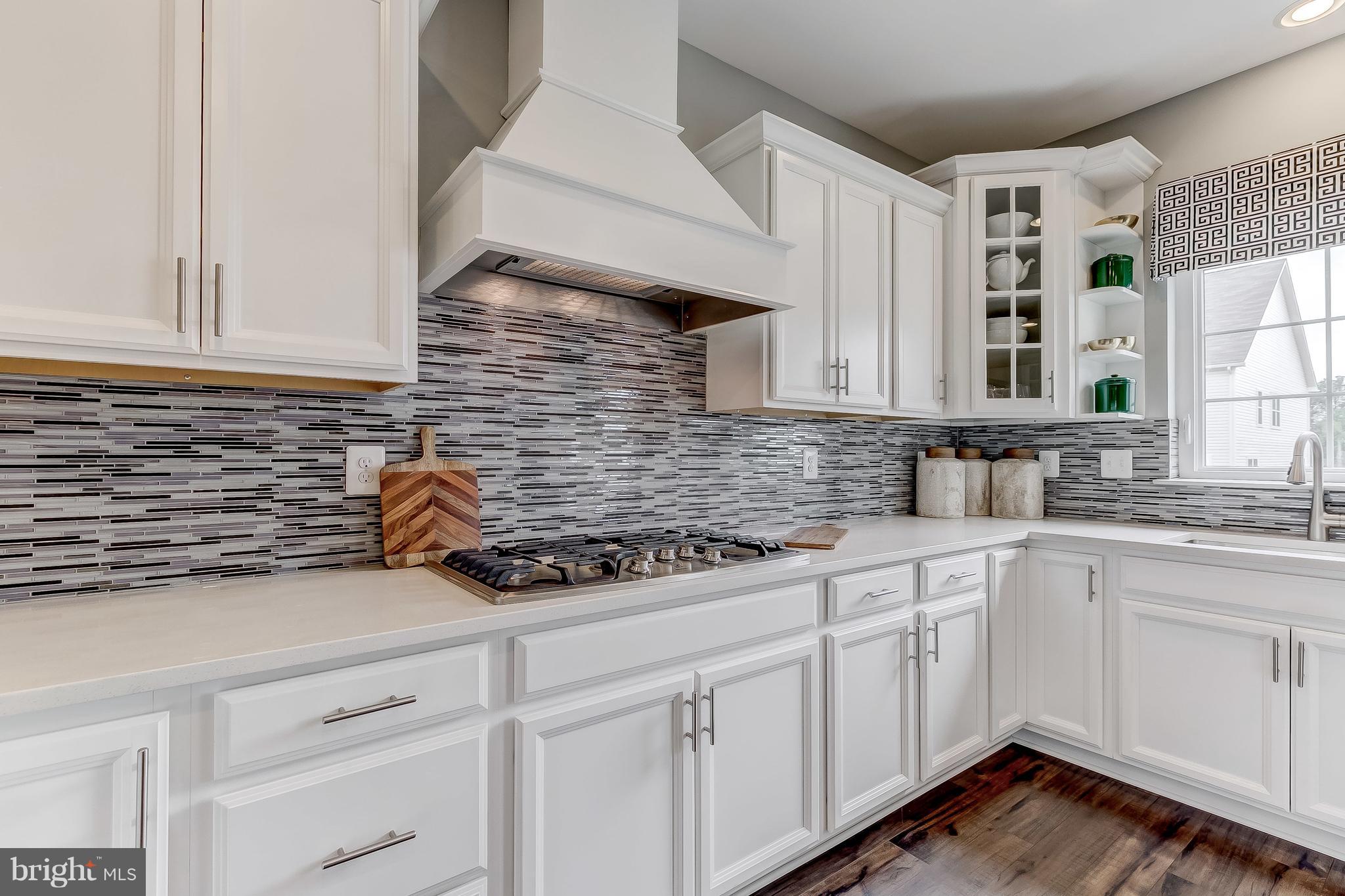 2710 Lady Slipper Road Gambrills, MD 21054 - Photo 13 of 46 a kitchen with stainless steel appliances white cabinets and a sink
