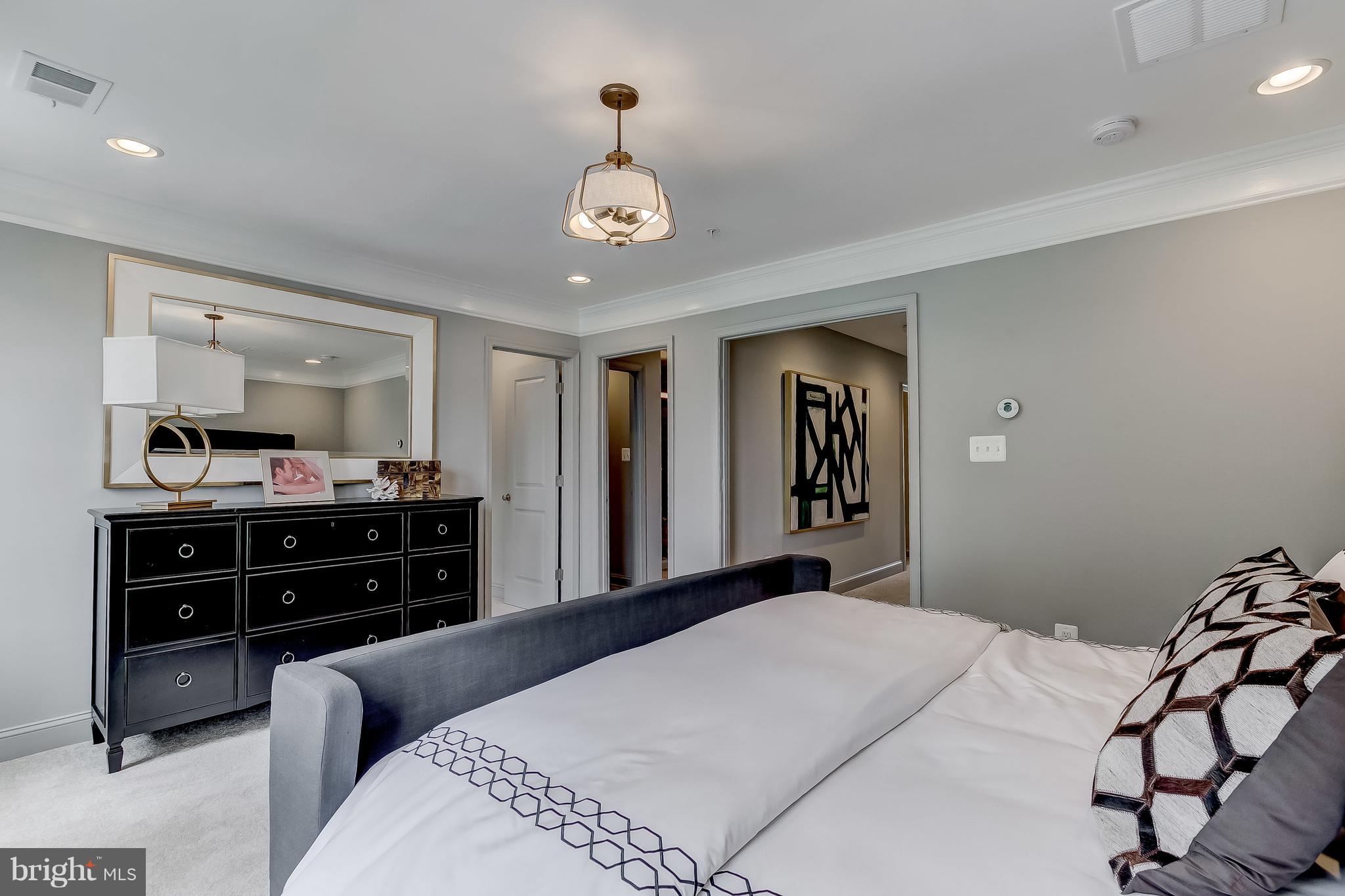 2710 Lady Slipper Road Gambrills, MD 21054 - Photo 19 of 46 a bedroom with a bed and a chandelier