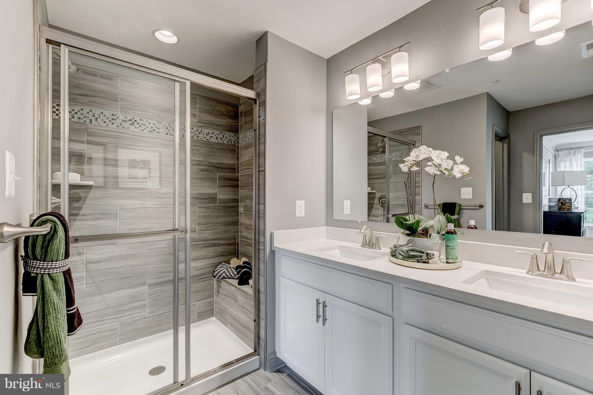 2710 Lady Slipper Road Gambrills, MD 21054 - Photo 20 of 46 a bathroom with a shower sink and mirror