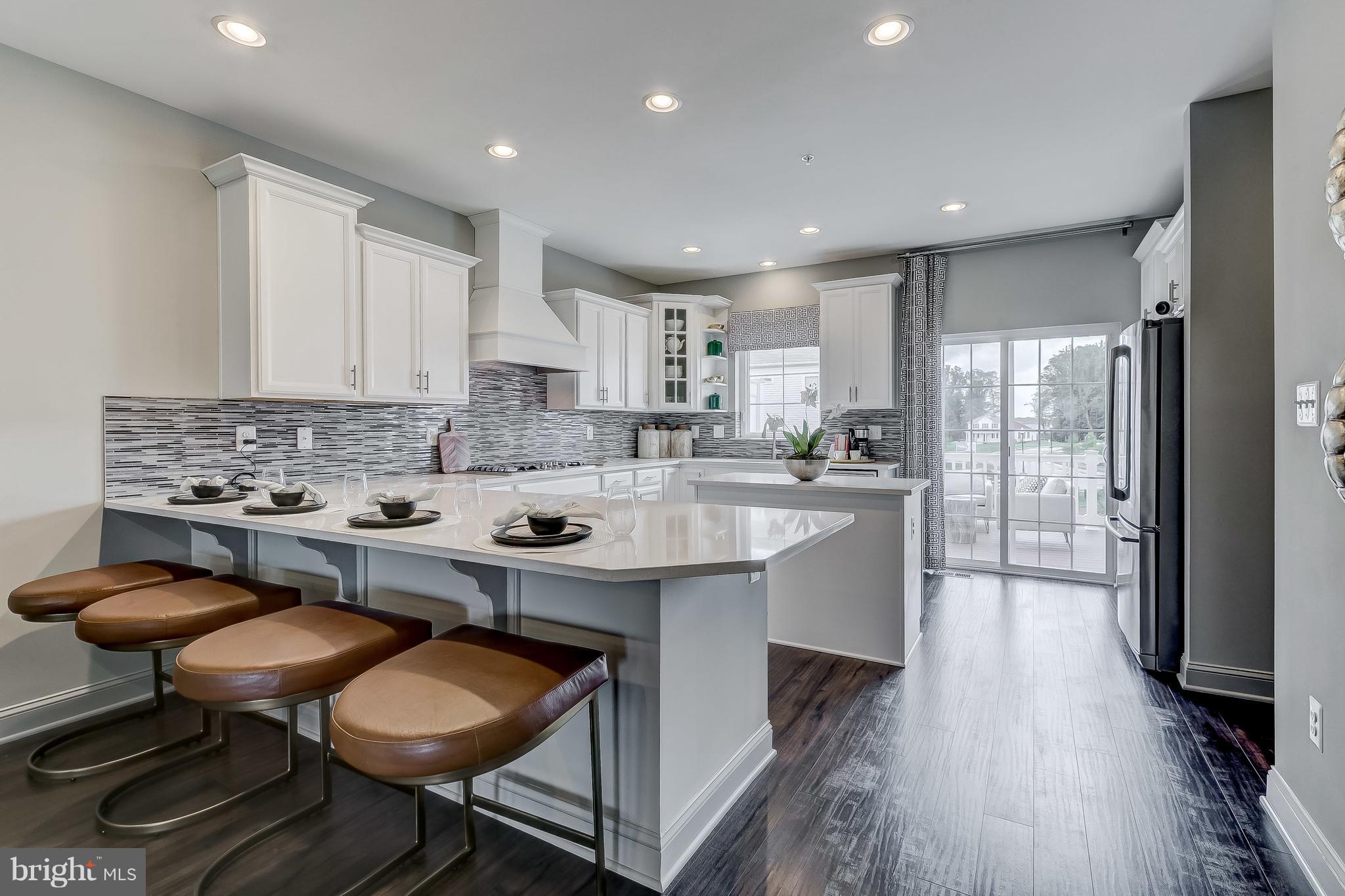 2710 Lady Slipper Road Gambrills, MD 21054 - Photo 10 of 46 a kitchen with a sink a table and chairs in it